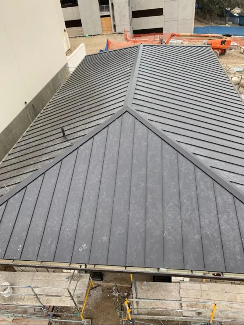 Commercial metal roof construction with crane equipment in Little Silver